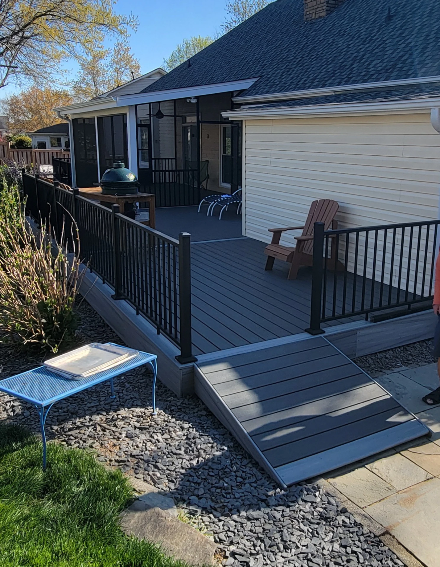 Composite deck with dark access ramp on the stones