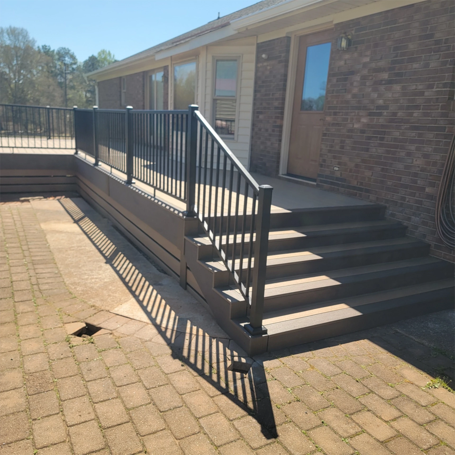 Elevated deck with black railing and stairs