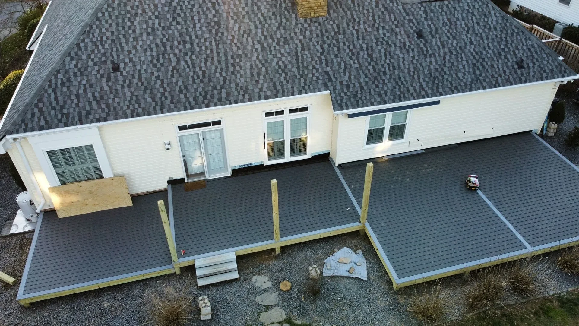 Large gray composite backyard deck under construction