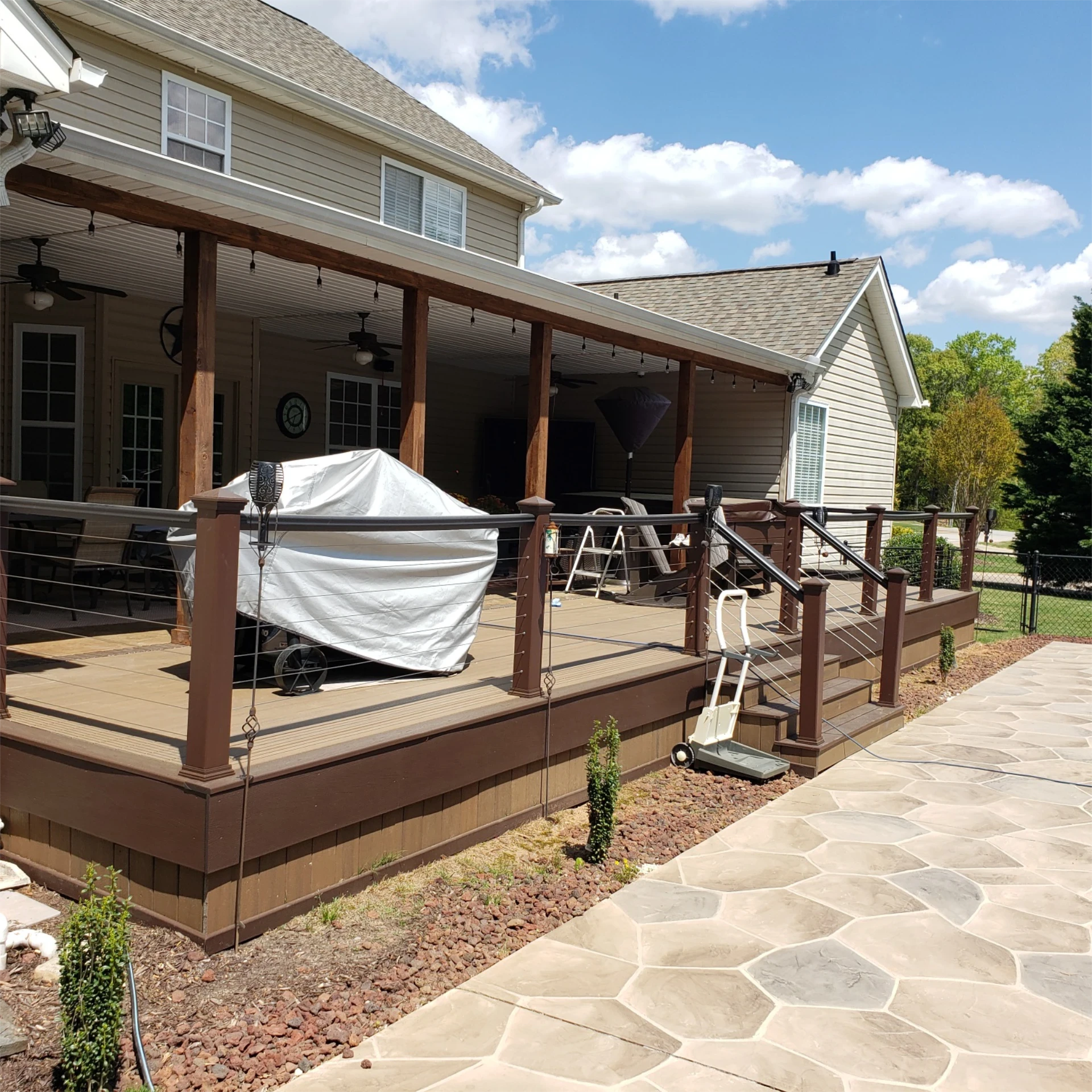 Backyard wooden deck and covered patio with stair