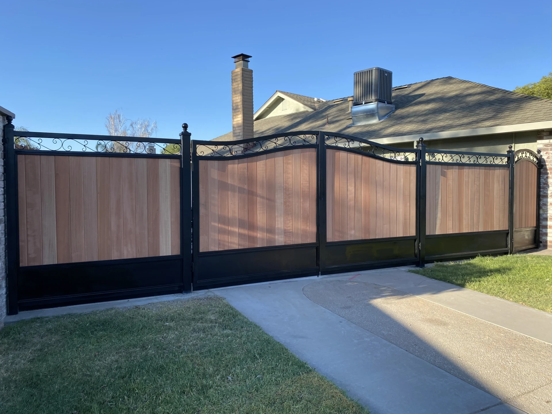 Black brown stock gate installation with blue sky view