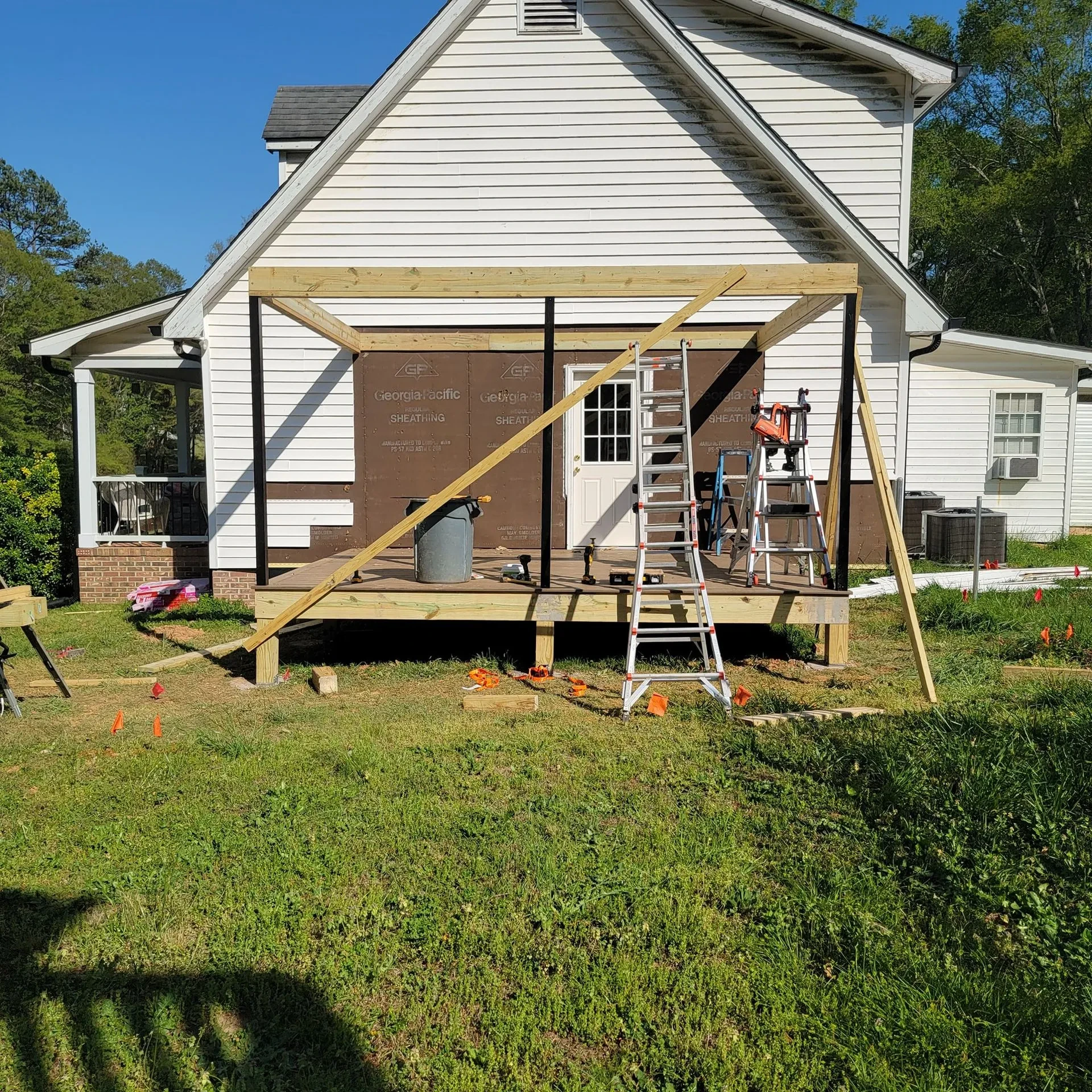 Front view of a deck framing under construction on the backyard