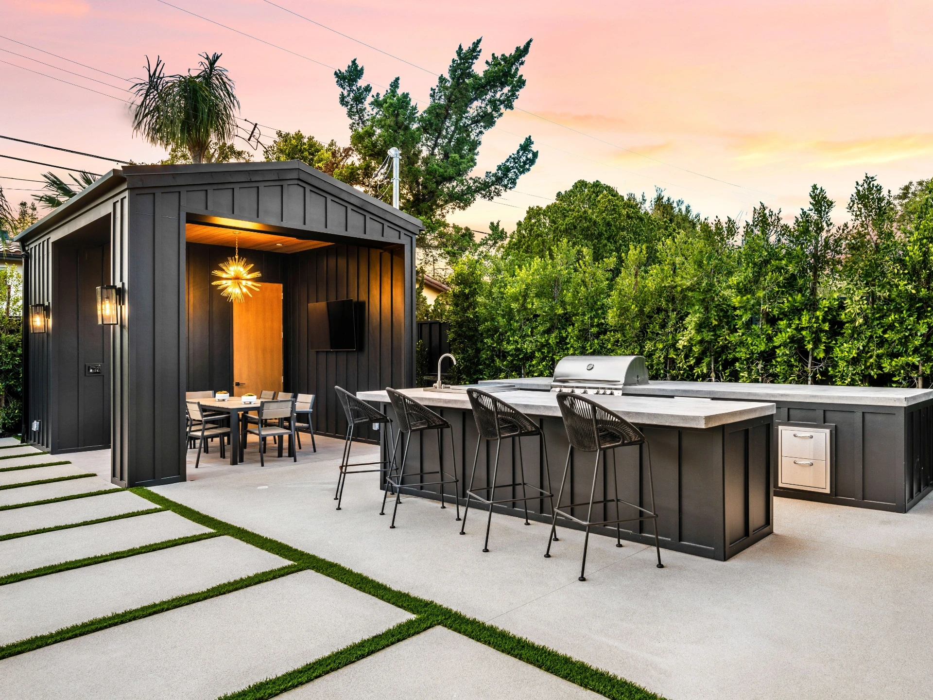 Modern outdoor kitchen and overlooking view dining area at sunset