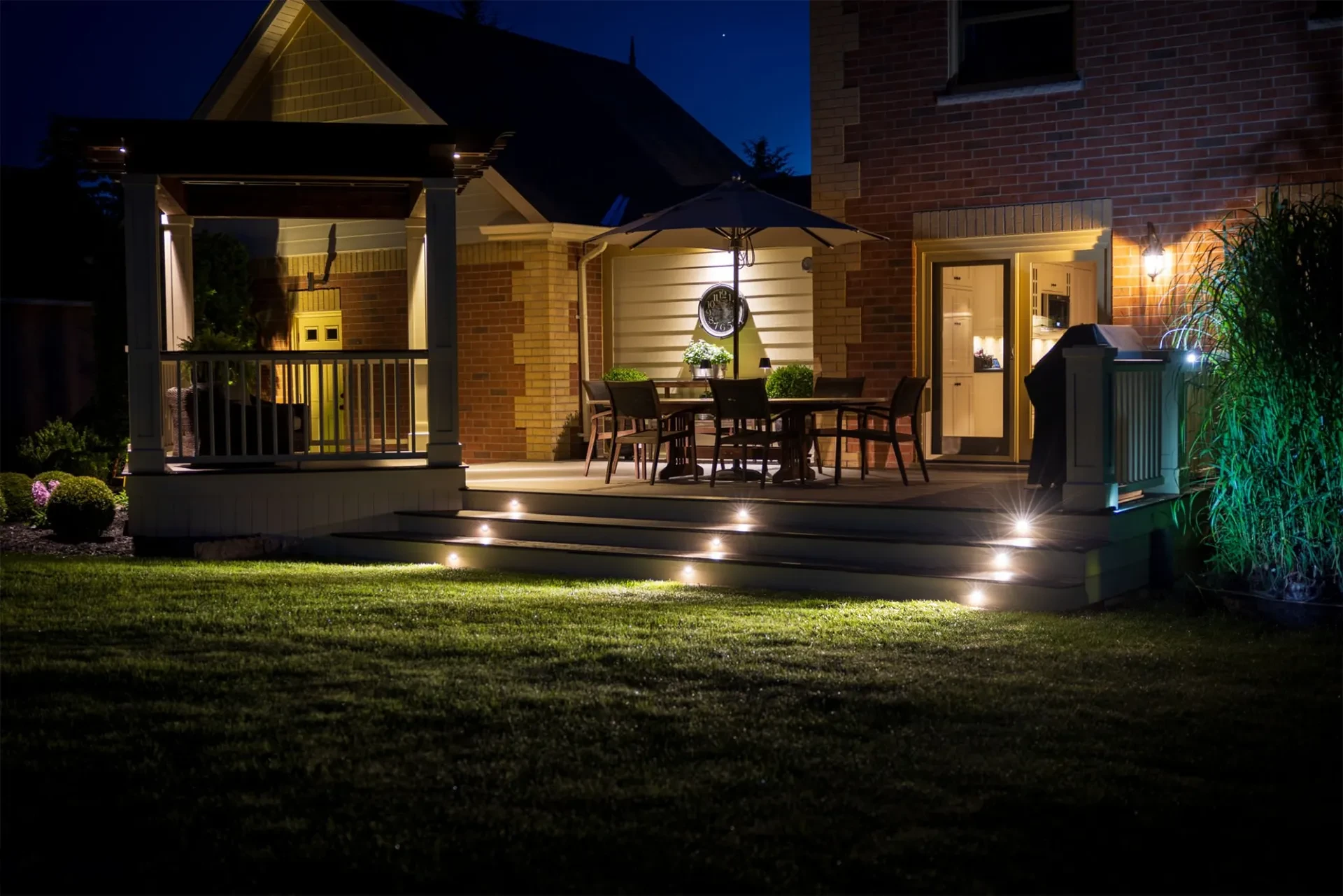 Residential deck lighting and night view with patio seating