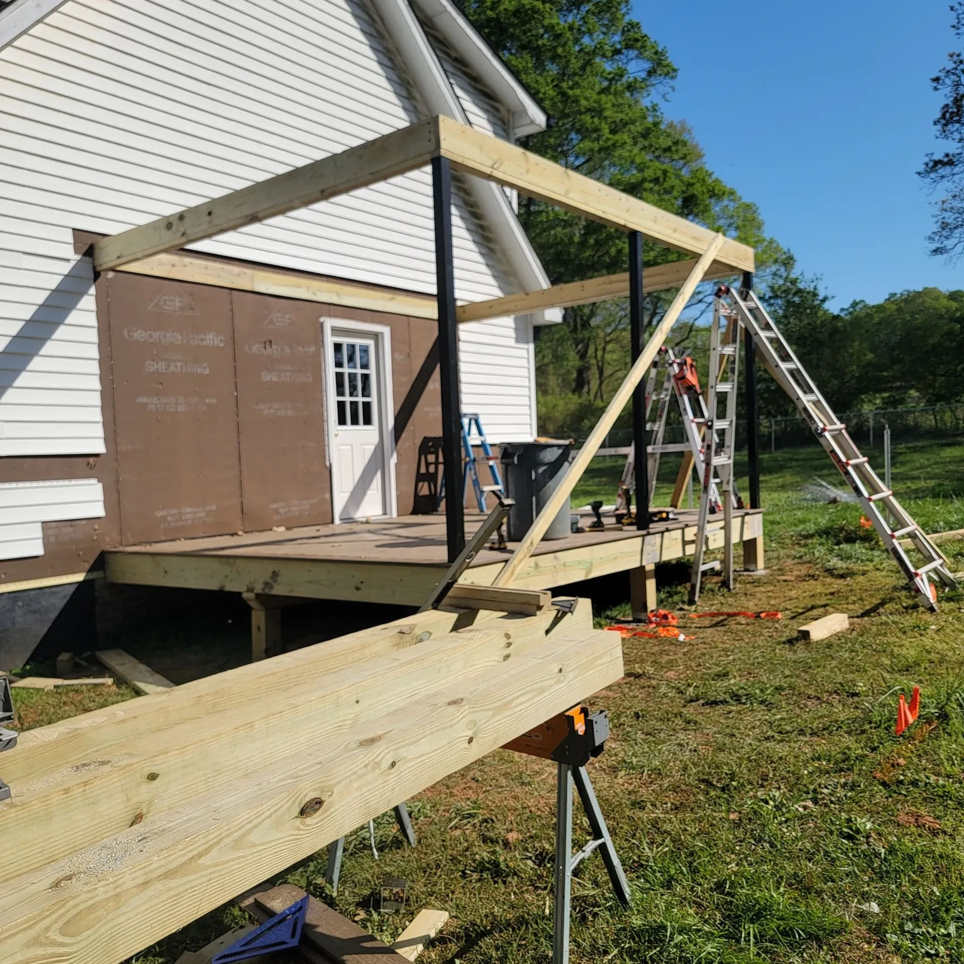 Side view of wooden deck roof framing under construction